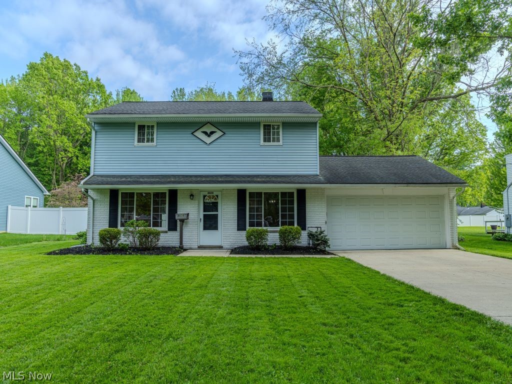 8828 Edgehill Road Mentor, OH 44060 - Photo 1 of 24 View of front of house with a garage, covered porch, and a front yard