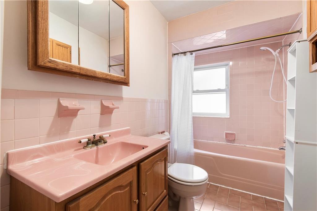 8745 17th Avenue Brooklyn, NY 11214 - Photo 14 of 31 a bathroom with a sink toilet a mirror and shower