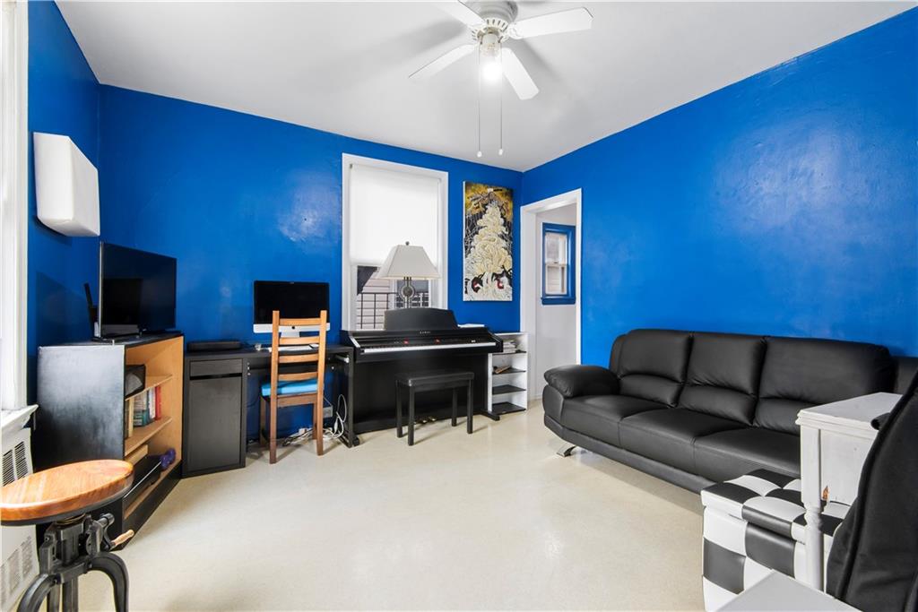 8745 17th Avenue Brooklyn, NY 11214 - Photo 15 of 31 a living room with furniture and a flat screen tv