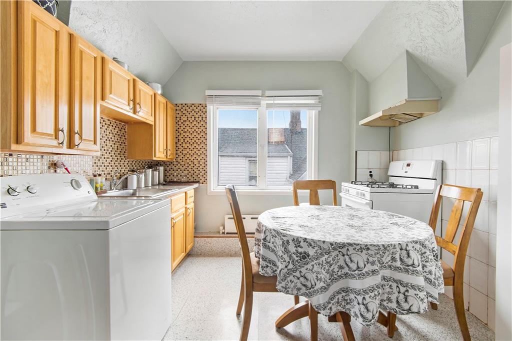 8745 17th Avenue Brooklyn, NY 11214 - Photo 21 of 31 a kitchen with stainless steel appliances granite countertop a stove a sink dishwasher and a refrigerator with wooden floor