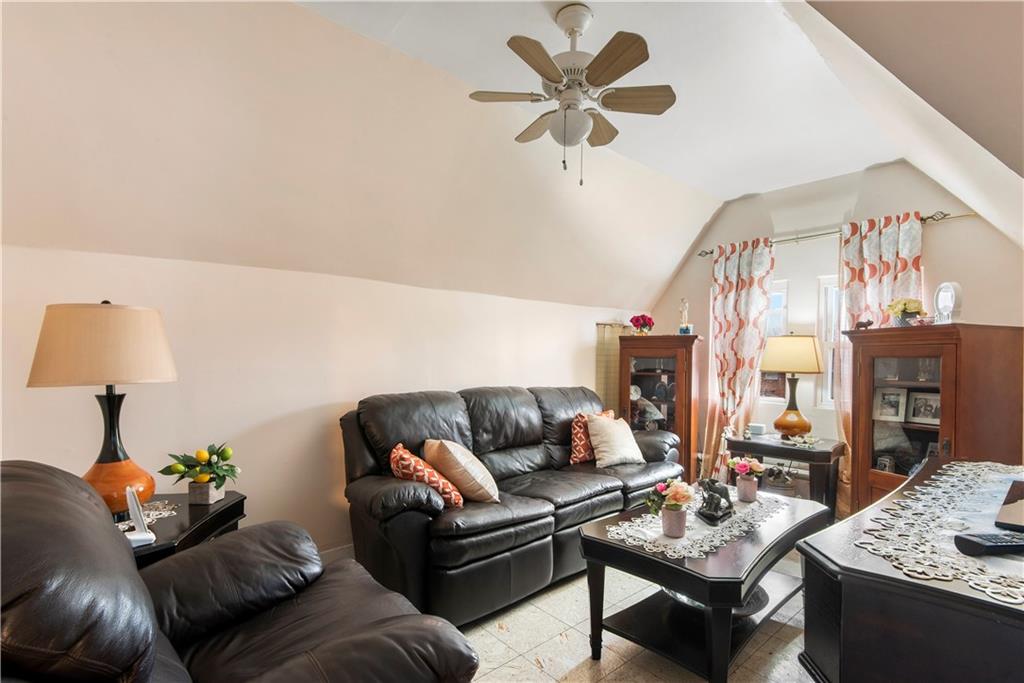 8745 17th Avenue Brooklyn, NY 11214 - Photo 23 of 31 a living room with furniture and a chandelier