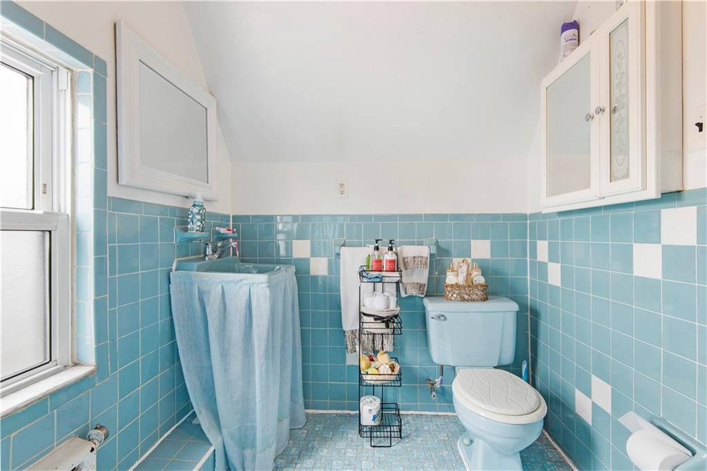8745 17th Avenue Brooklyn, NY 11214 - Photo 26 of 31 a bathroom with a toilet and a shower