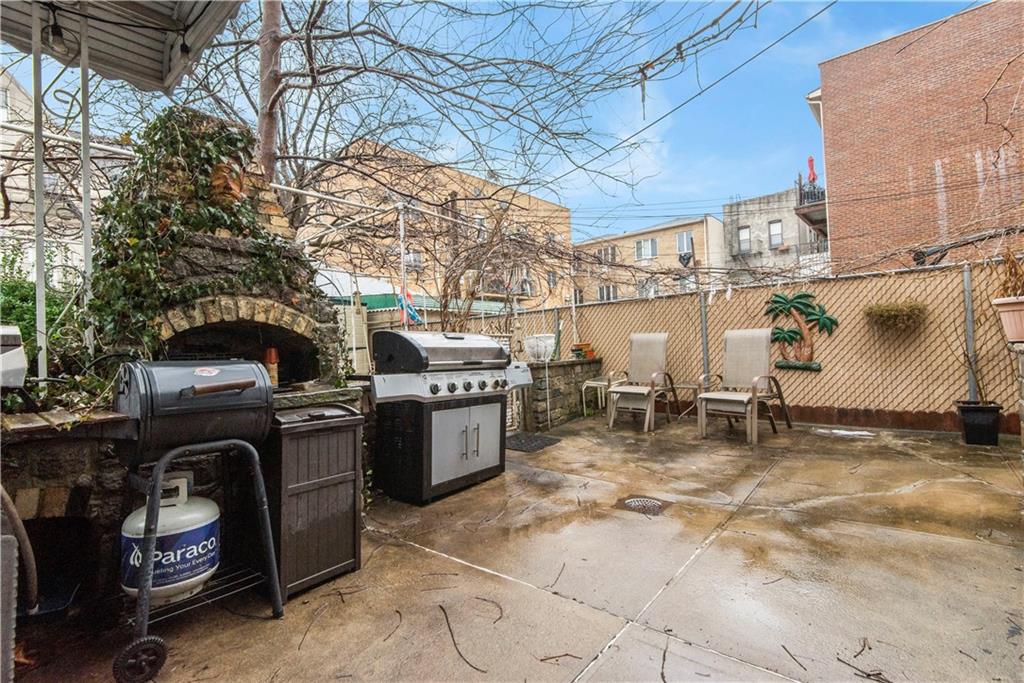 8745 17th Avenue Brooklyn, NY 11214 - Photo 28 of 31 a view of roof deck with table and chairs and potted plants
