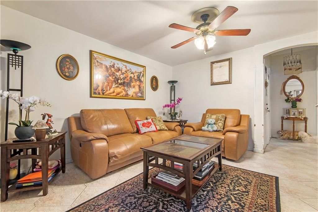 8745 17th Avenue Brooklyn, NY 11214 - Photo 3 of 31 a reading room with furniture and a rug