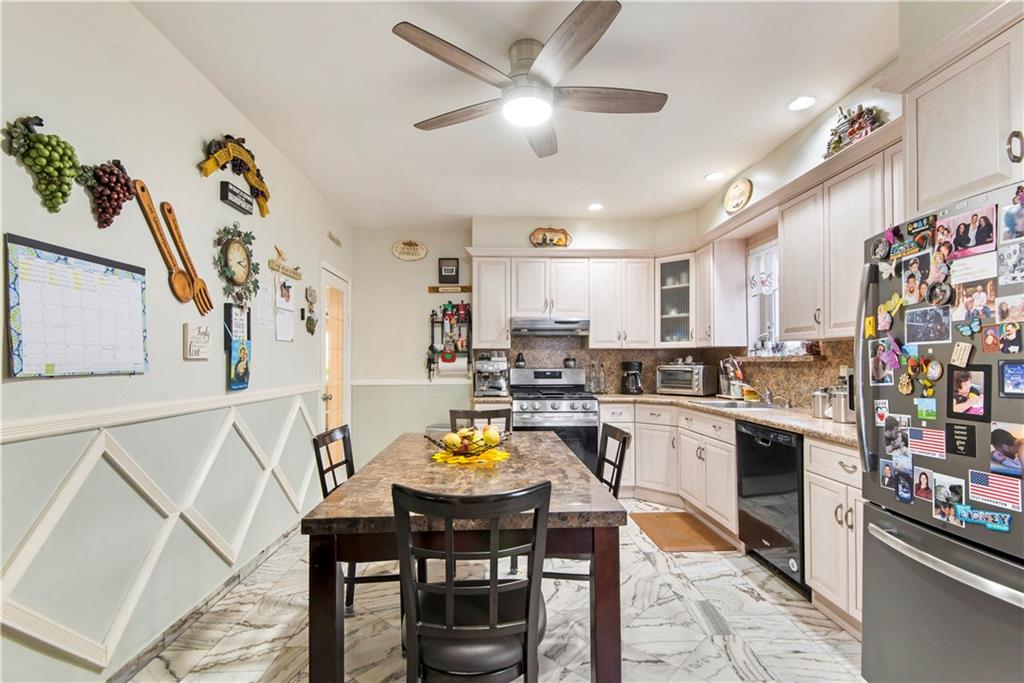 8745 17th Avenue Brooklyn, NY 11214 - Photo 5 of 31 a view of a dining room with furniture and a kitchen