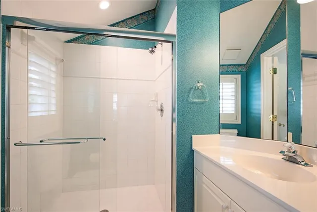 a bathroom with a shower and a sink