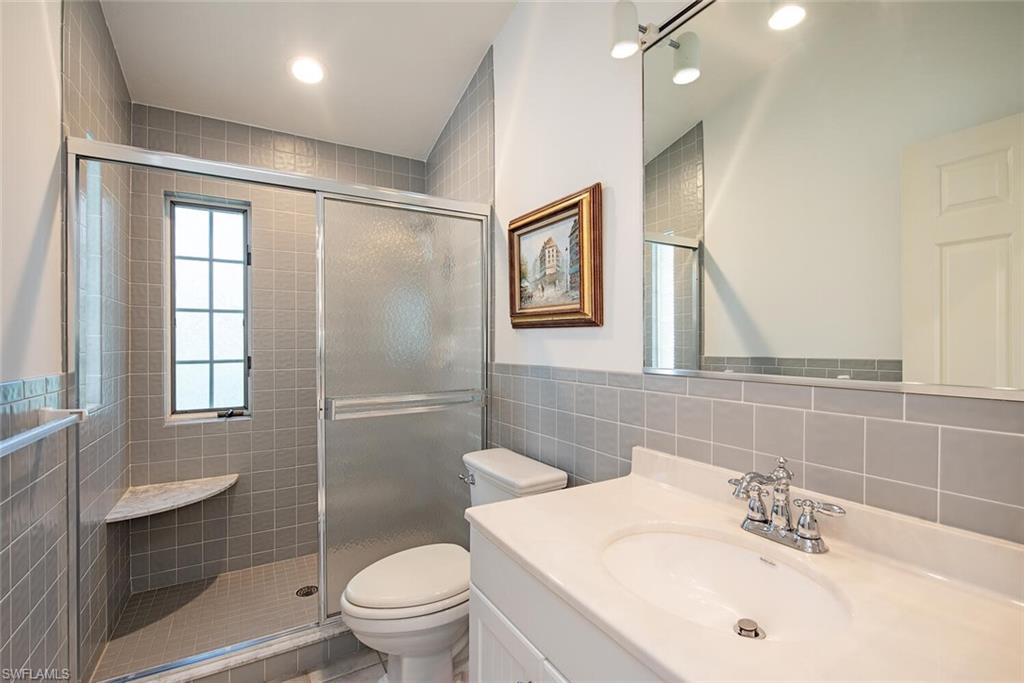 369 2nd Avenue North Naples, FL 34102 - Photo 21 of 25 a bathroom with a sink toilet and shower