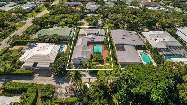 an aerial view of a house with a yard