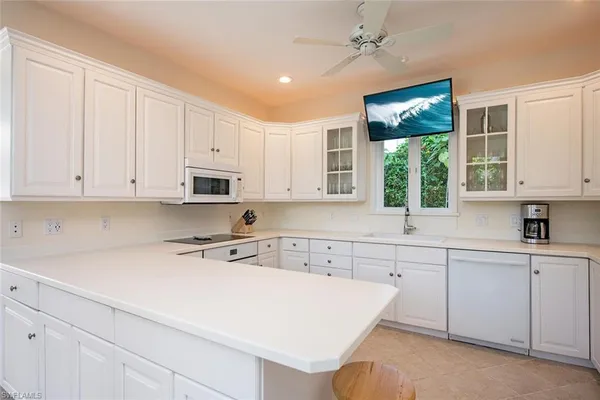 a kitchen with a sink window and cabinets