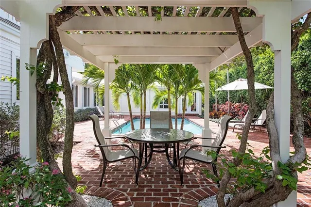 a view of a patio with table and chairs and potted plants