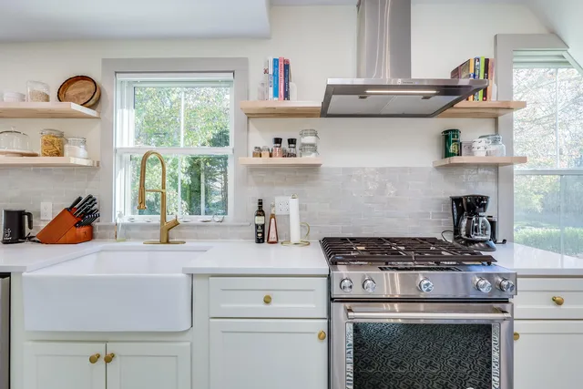 a kitchen with stainless steel appliances granite countertop a stove and a sink