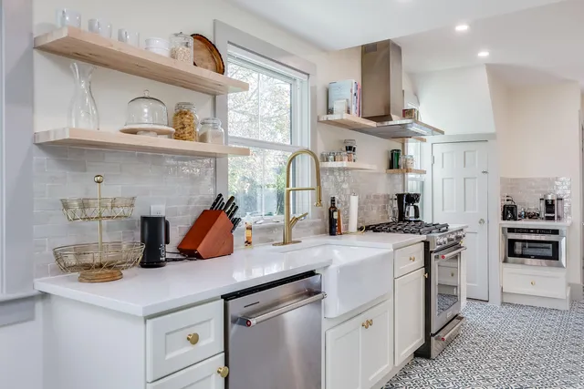 a kitchen with a sink a stove and cabinets