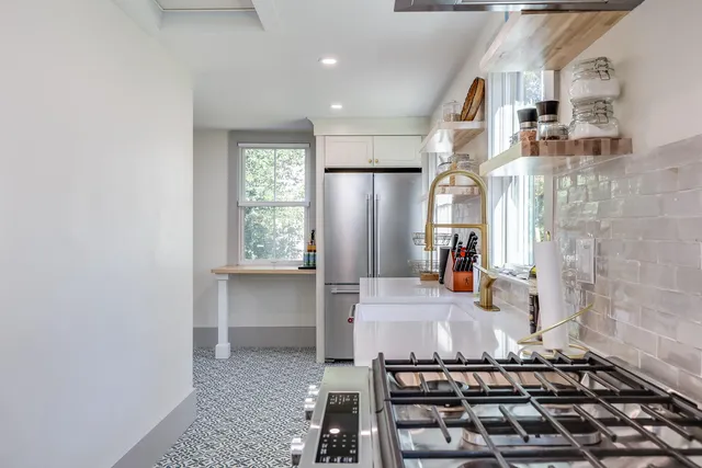 a bathroom with a granite countertop sink a mirror and shower