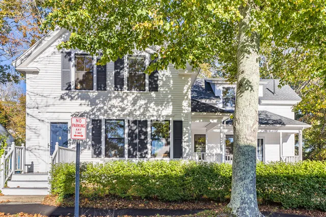 front view of a house with a tree