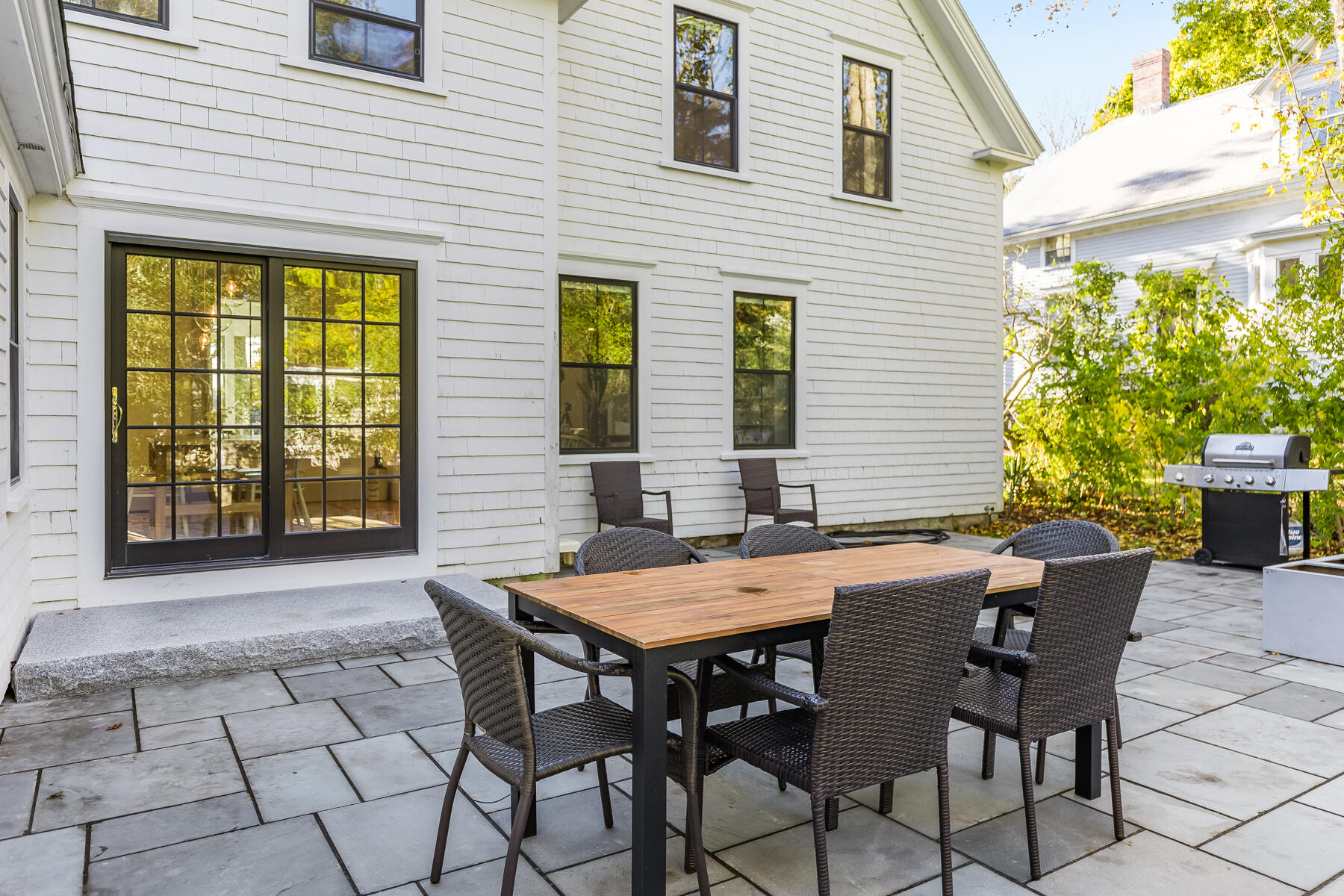 3 High Street Falmouth, MA 02543 - Photo 49 of 52 a view of a patio with a table and chairs and potted plants