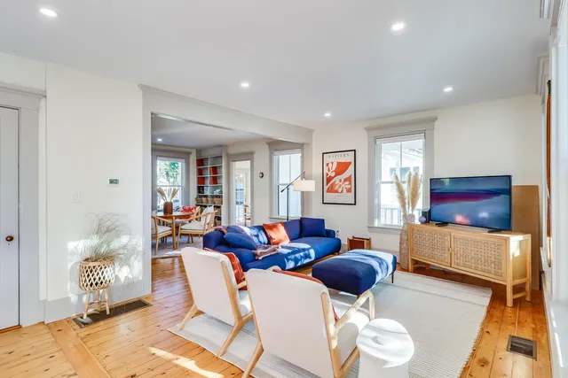 a living room with furniture a rug and a table