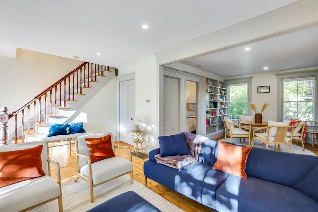 a living room with furniture fireplace and a wooden floor