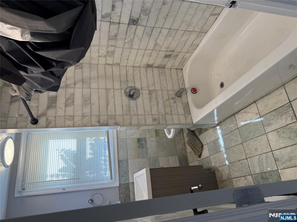 753 South 11th Street, Unit 1 Newark, NJ 07103 - Photo 1 of 17 a bathroom with a bathtub and a shower