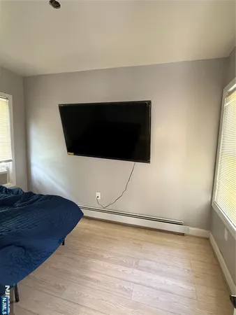 a living room with a flat screen tv and a floor to ceiling window