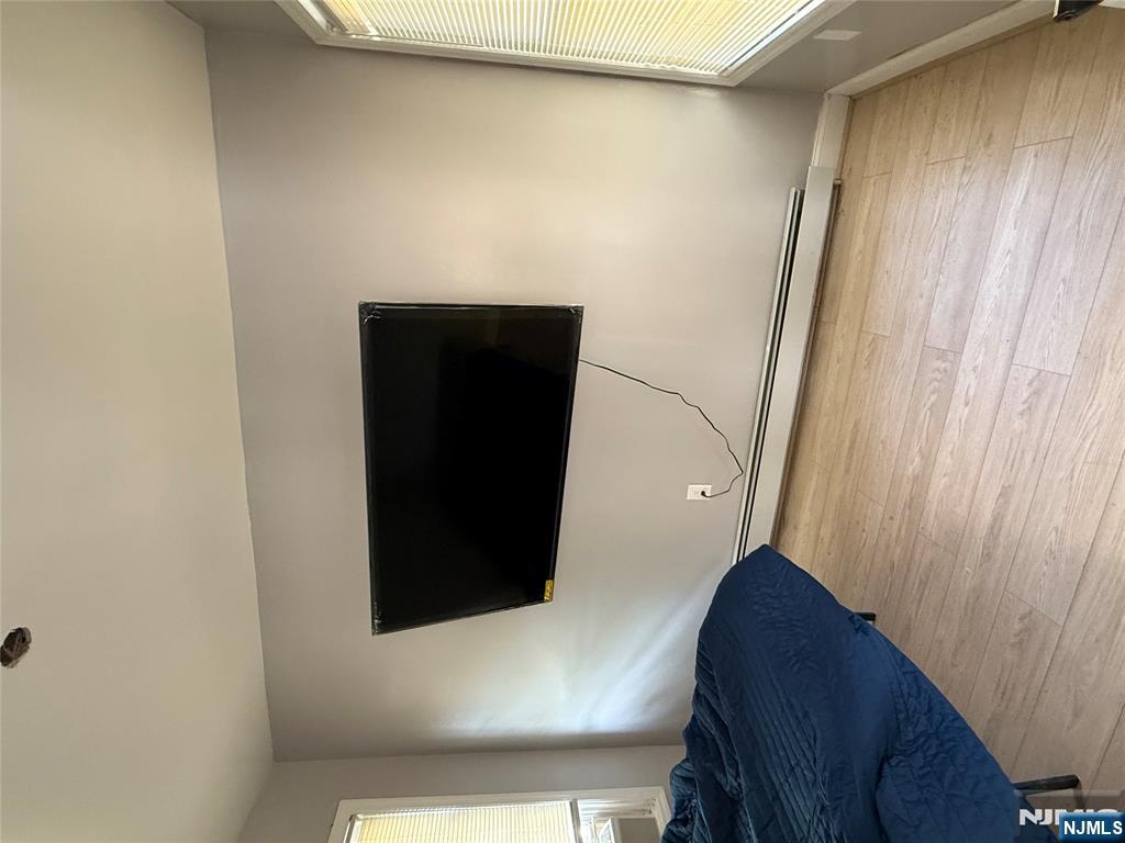 753 South 11th Street, Unit 1 Newark, NJ 07103 - Photo 14 of 17 a living room with a flat screen tv and a floor to ceiling window