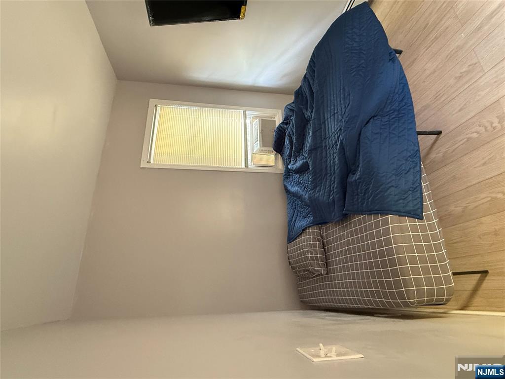 753 South 11th Street, Unit 1 Newark, NJ 07103 - Photo 15 of 17 a bedroom with a bed and a window