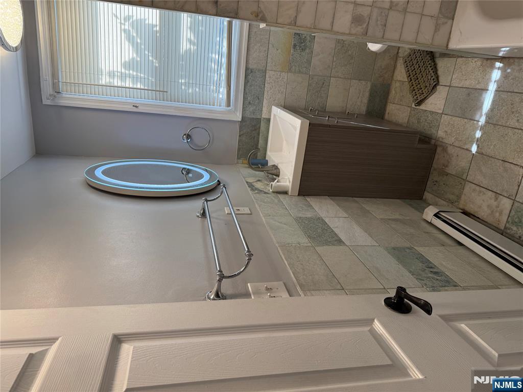 753 South 11th Street, Unit 1 Newark, NJ 07103 - Photo 2 of 17 a bathroom with a sink a vanity and a mirror