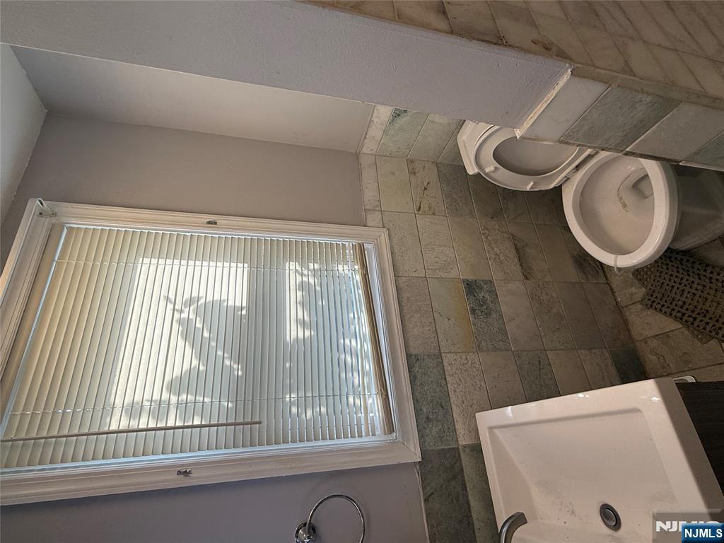 753 South 11th Street, Unit 1 Newark, NJ 07103 - Photo 3 of 17 a bathroom with a sink a toilet and a window