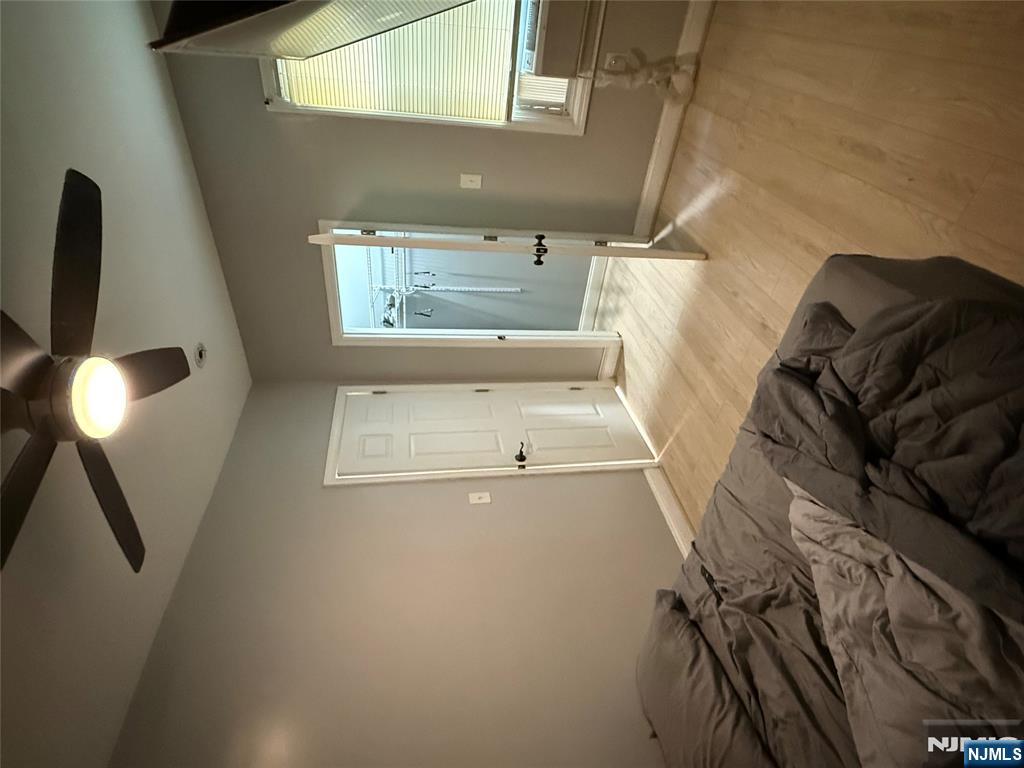 753 South 11th Street, Unit 1 Newark, NJ 07103 - Photo 4 of 17 a bedroom with a bed and a chandelier