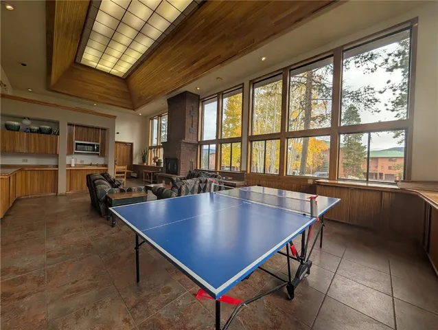 a room with pool table and windows