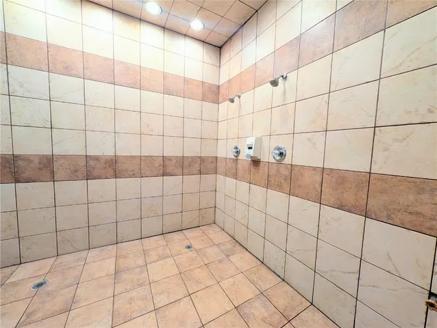 a view of a swimming pool with a couches chairs and a table