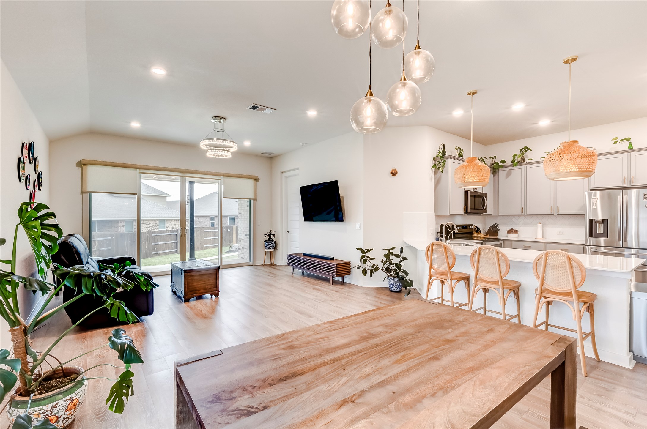 917 Balsora Cove Georgetown, TX 78628 - Photo 17 of 39 Dining room with light wood-style floors, lofted ceiling, and suspended lighting