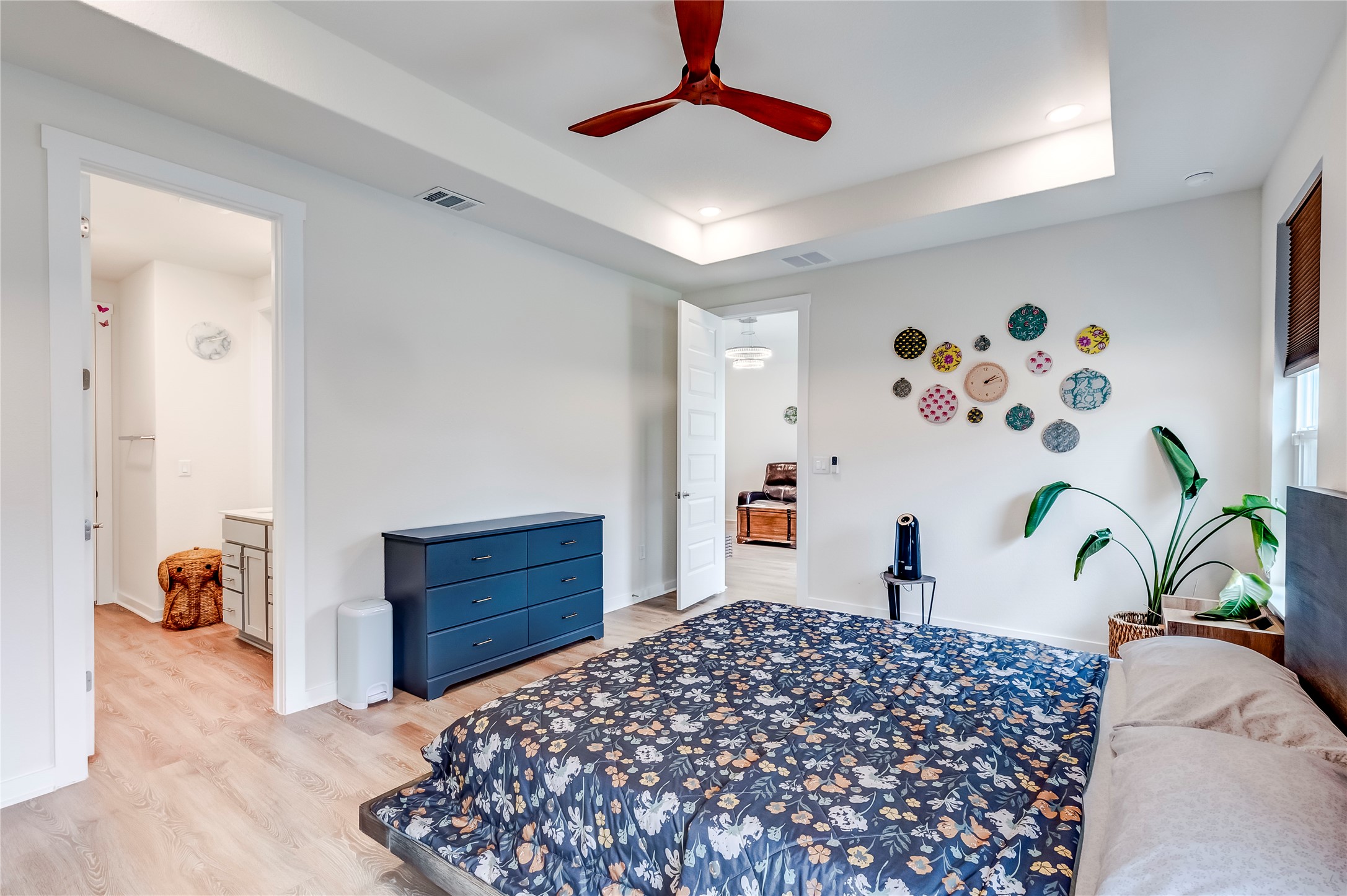 917 Balsora Cove Georgetown, TX 78628 - Photo 20 of 39 Bedroom with light wood-style flooring, a raised ceiling, recessed lighting, ceiling fan, and connected bathroom