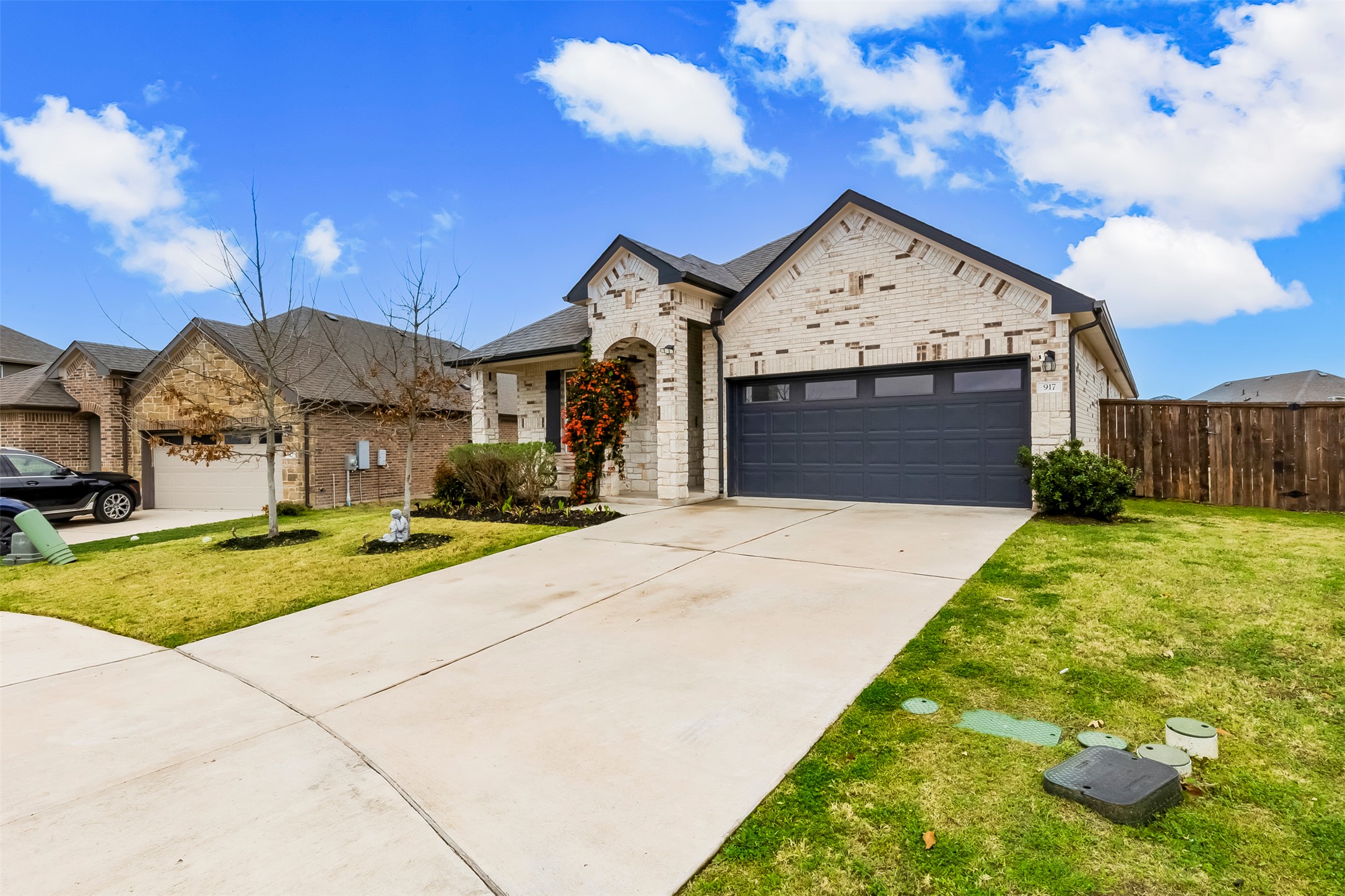 917 Balsora Cove Georgetown, TX 78628 - Photo 2 of 39 French country inspired facade featuring concrete driveway, a garage, brick siding, and a residential view