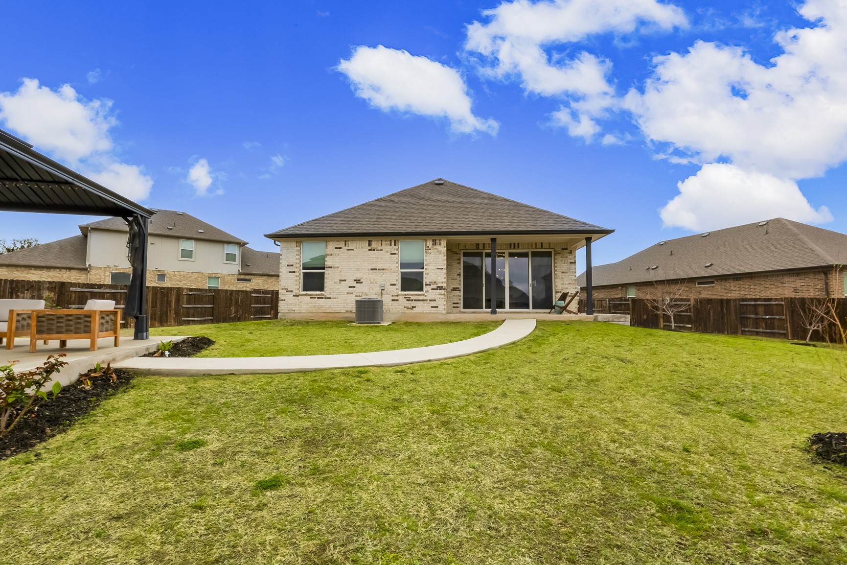 917 Balsora Cove Georgetown, TX 78628 - Photo 32 of 39 Back of house featuring a fenced backyard, brick siding, and a patio