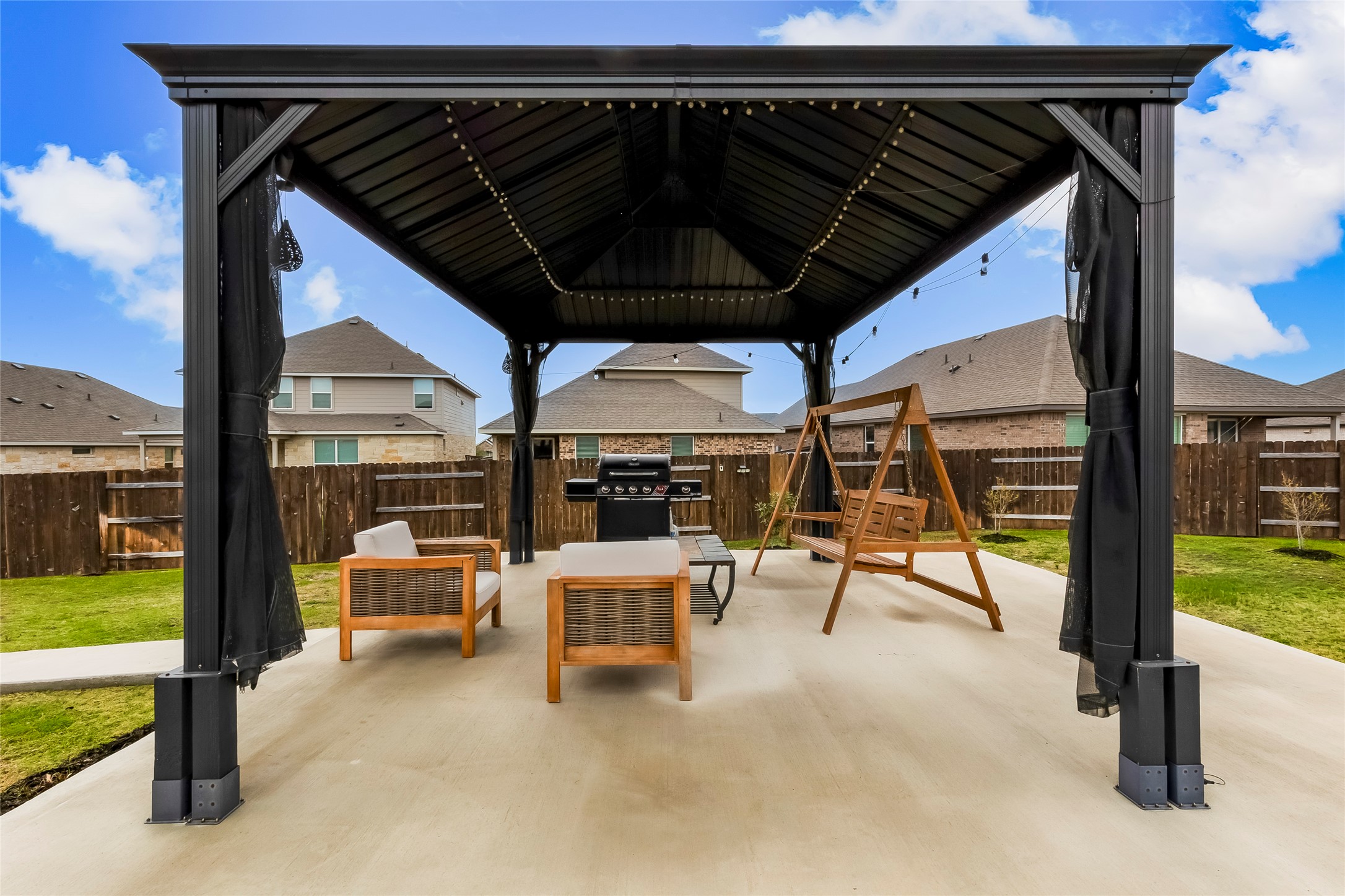 917 Balsora Cove Georgetown, TX 78628 - Photo 36 of 39 Fenced backyard featuring a patio, grilling area, a gazebo, and a residential view