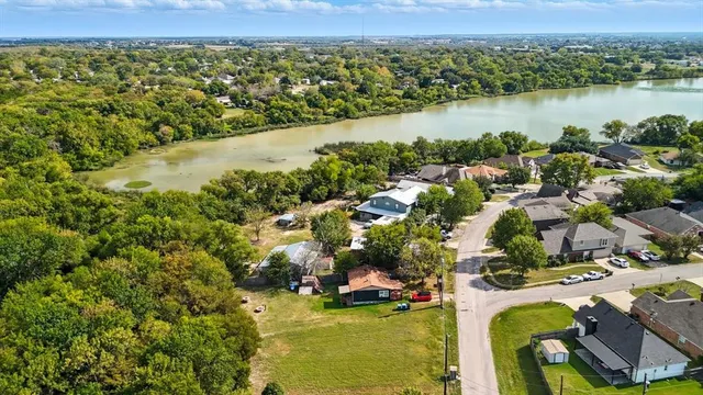 an aerial view of residential houses with outdoor space and river