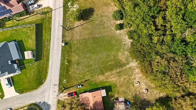 an aerial view of residential houses with outdoor space