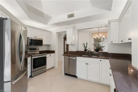 a kitchen with granite countertop a sink and stainless steel appliances