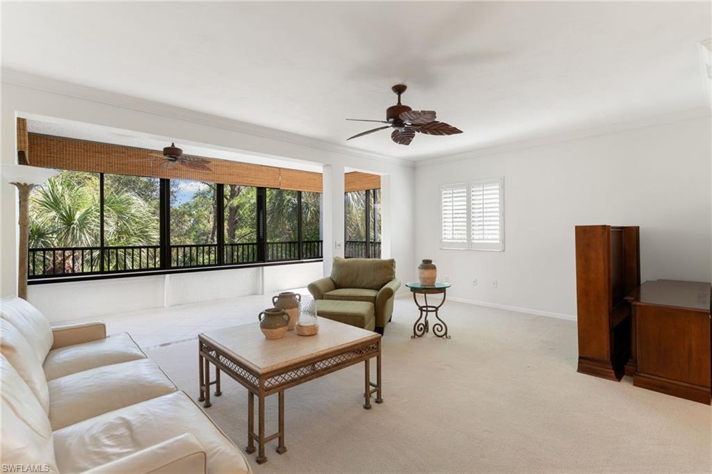 6500 Valen Way, Unit A203 Naples, FL 34108 - Photo 13 of 28 a living room with furniture and a large window
