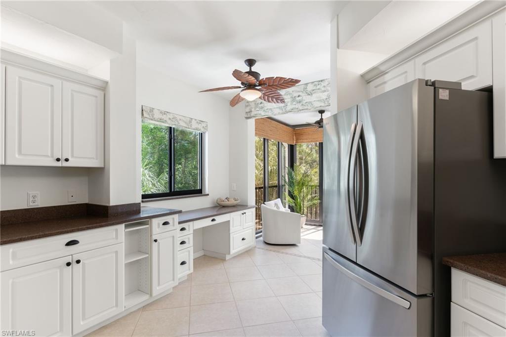 6500 Valen Way, Unit A203 Naples, FL 34108 - Photo 2 of 28 a kitchen with stainless steel appliances granite countertop a refrigerator a sink a stove and white cabinets