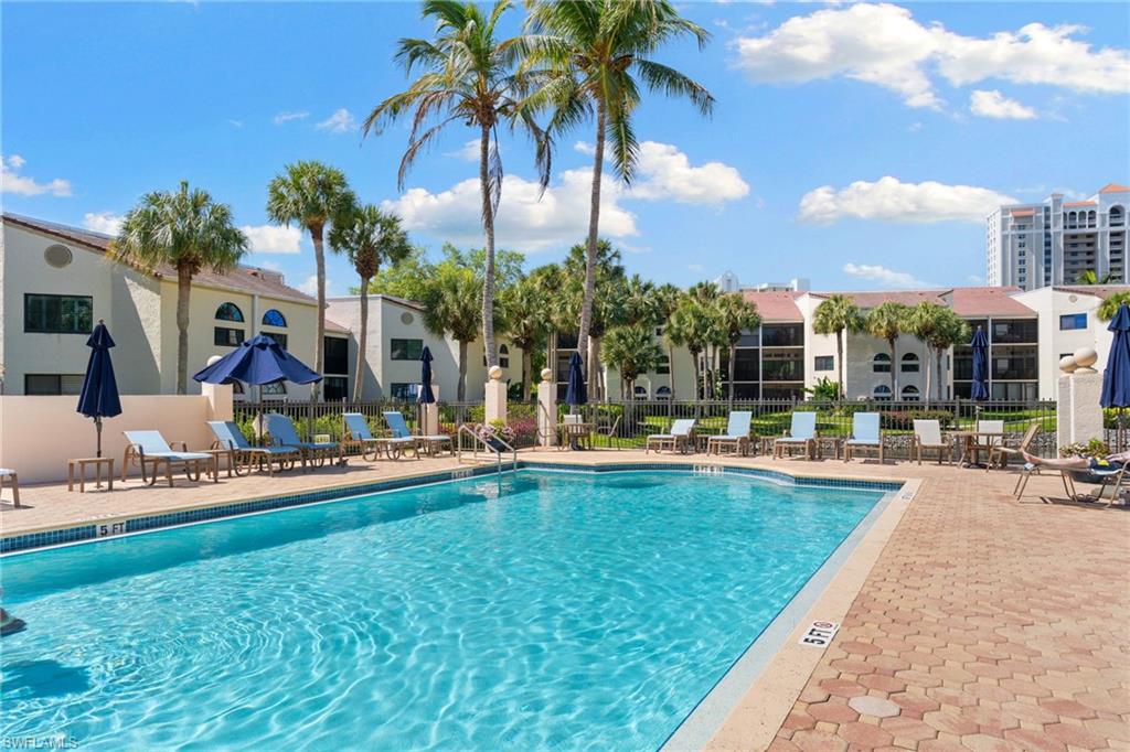 6500 Valen Way, Unit A203 Naples, FL 34108 - Photo 24 of 28 a swimming pool with outdoor seating and yard