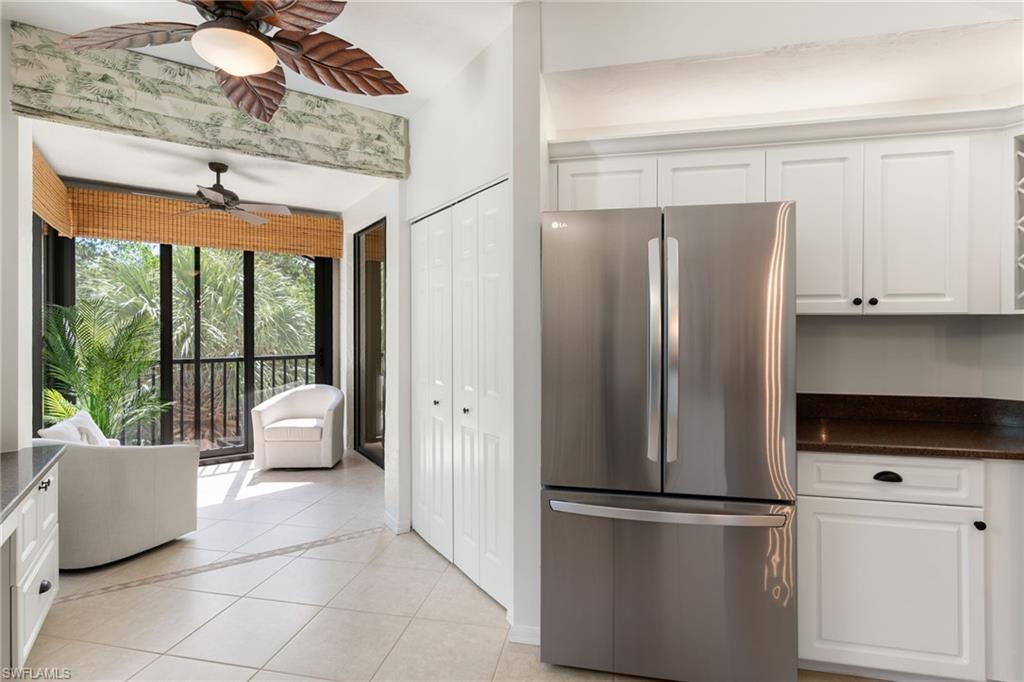 6500 Valen Way, Unit A203 Naples, FL 34108 - Photo 3 of 28 a kitchen with stainless steel appliances granite countertop a refrigerator and a stove