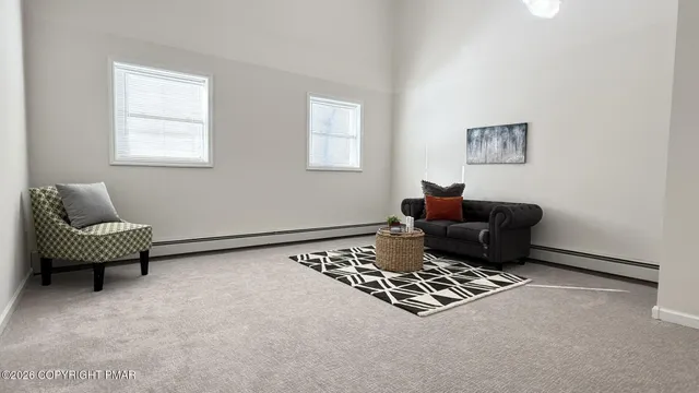 a living room with furniture rug and a window