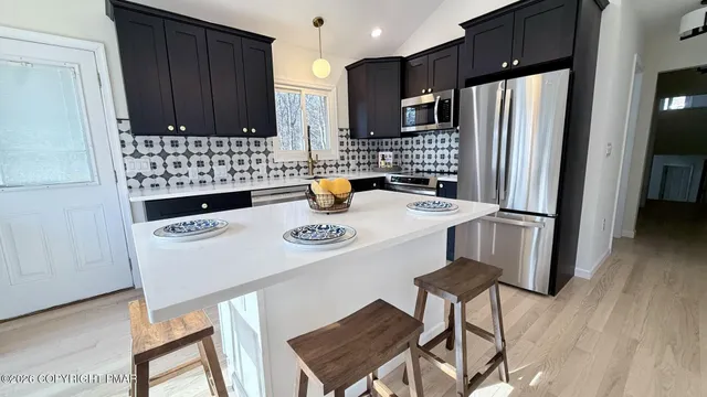 a kitchen with a refrigerator a stove a sink and a cabinets
