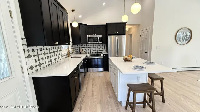 a kitchen with a sink a stove and chairs