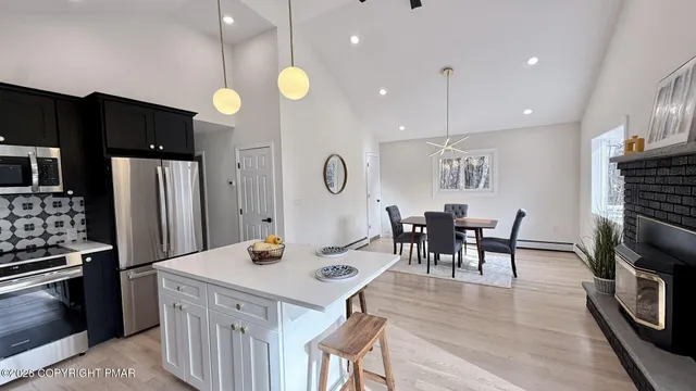 a kitchen with a sink a stove and chairs