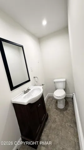 a bathroom with a toilet and a window