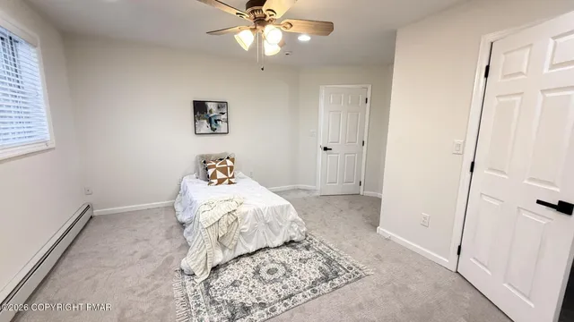a bedroom with bed and window