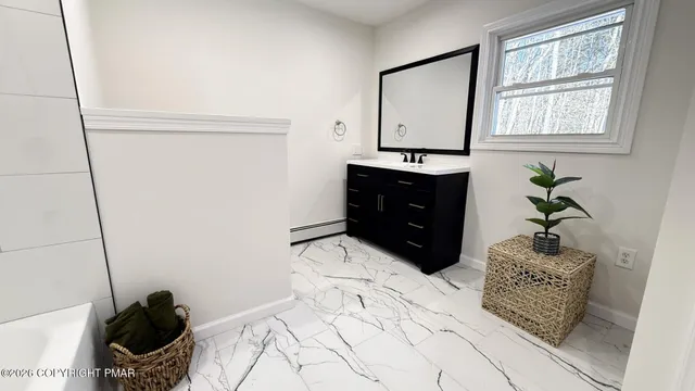 a bathroom with a bathtub and a sink