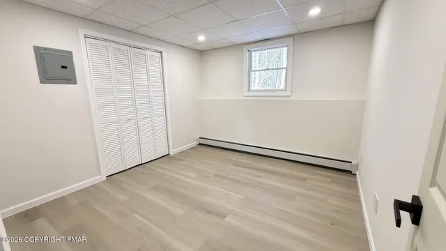 a work room with furniture and a wooden floor
